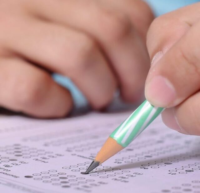 cropped-Man-Writing-Competitive-Exam.jpeg